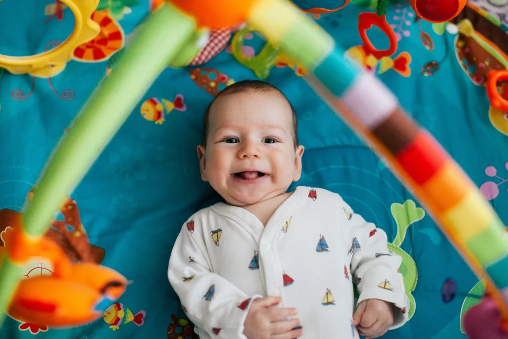 baby smiling, photo through play pen