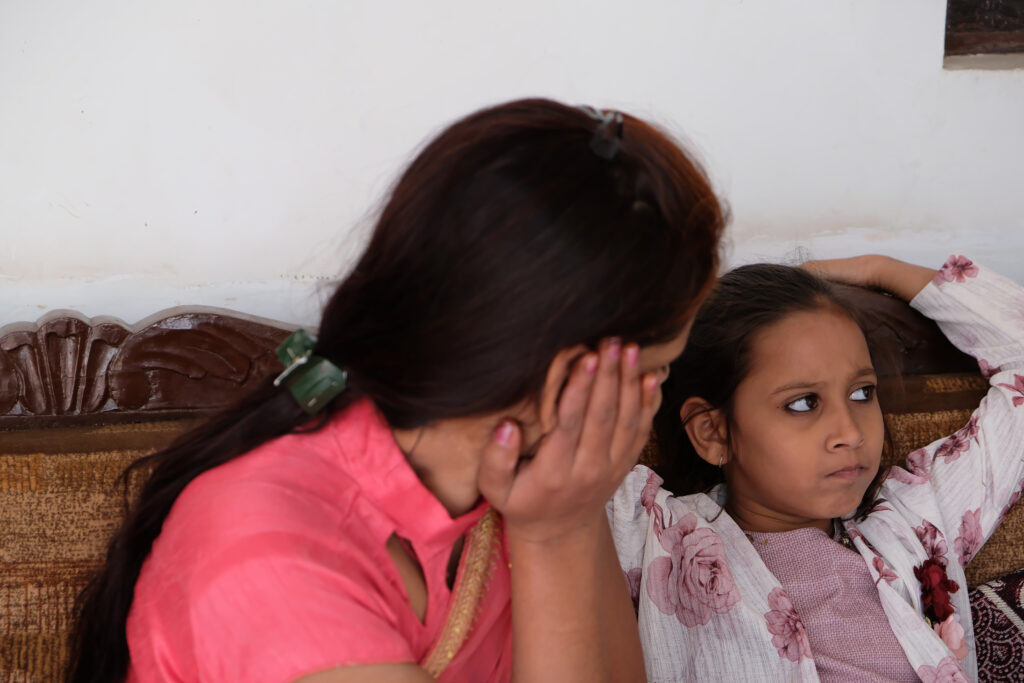 Closeup shot of an Indian woman talking to her daughter while sitting on a couch Closeup shot of an Indian woman talking to daughter while she is refusing to listen