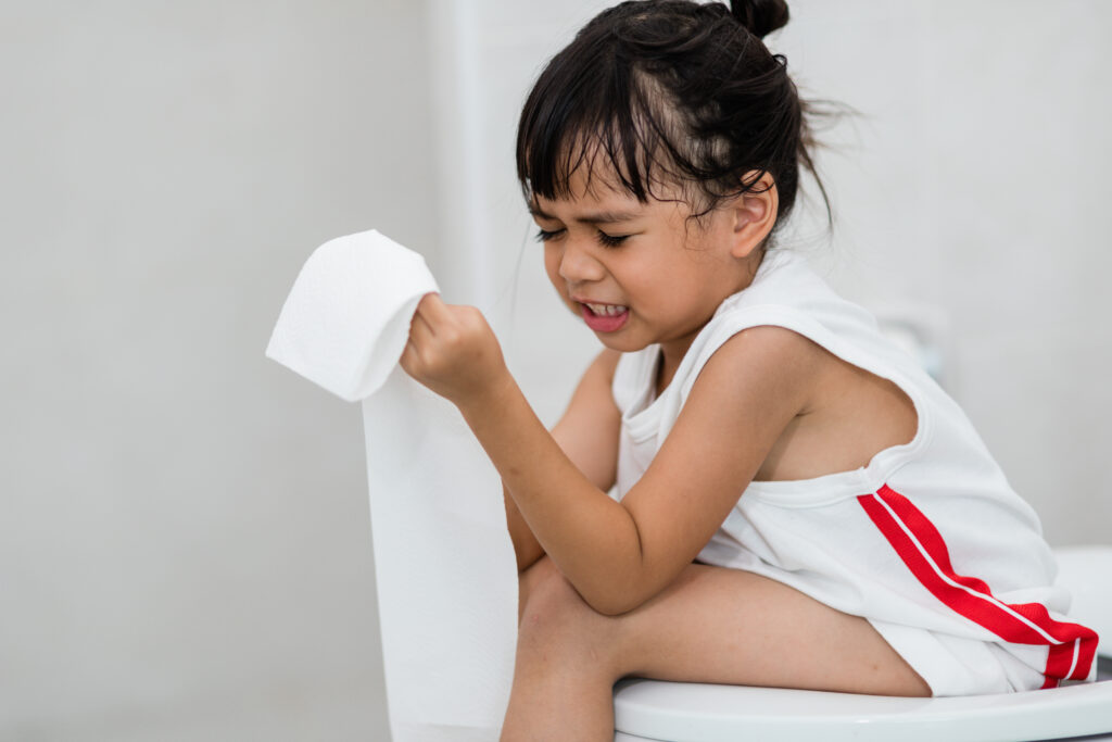 The little girl is sitting on the toilet suffering from constipa girl sitting on toilet seat ,difficult to potty