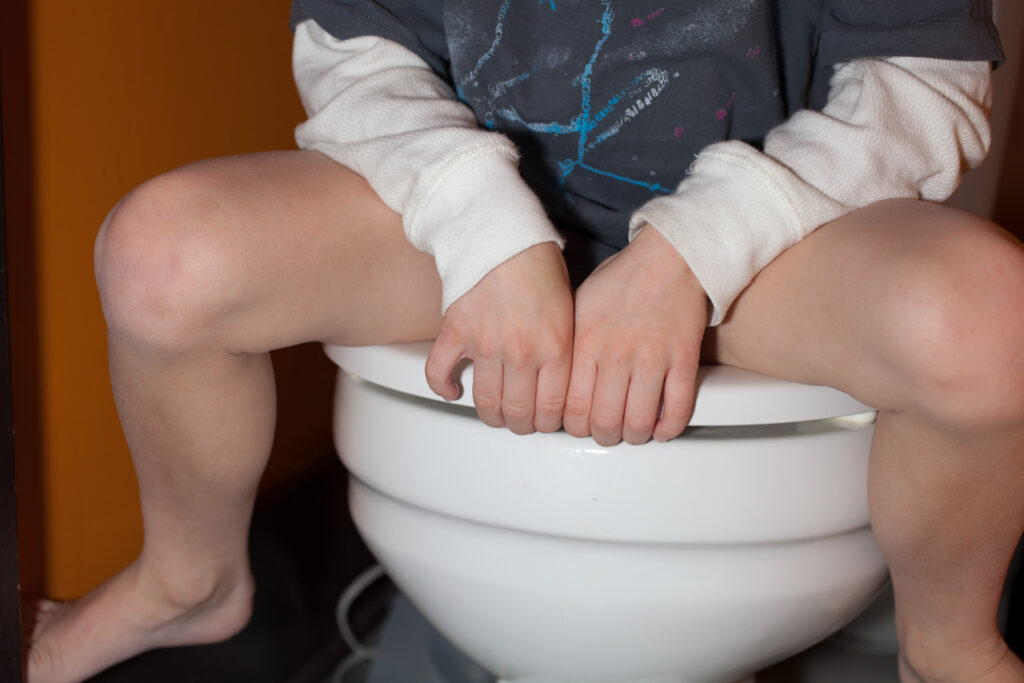 Boy sitting on toilet child sitting on toilet seat for toilet training