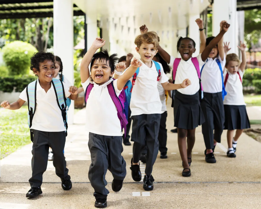 group of children getting out of school as break starts