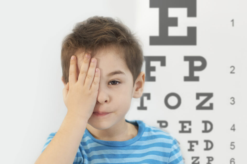 Little boy having eye test at ophthalmologist office child getting his eye test