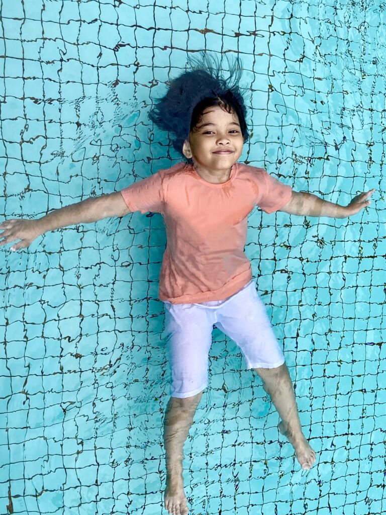 little-girl-floating-in-the-swimming-pool-2024-11-25-23-27-10-utc girl enjoying in the pool