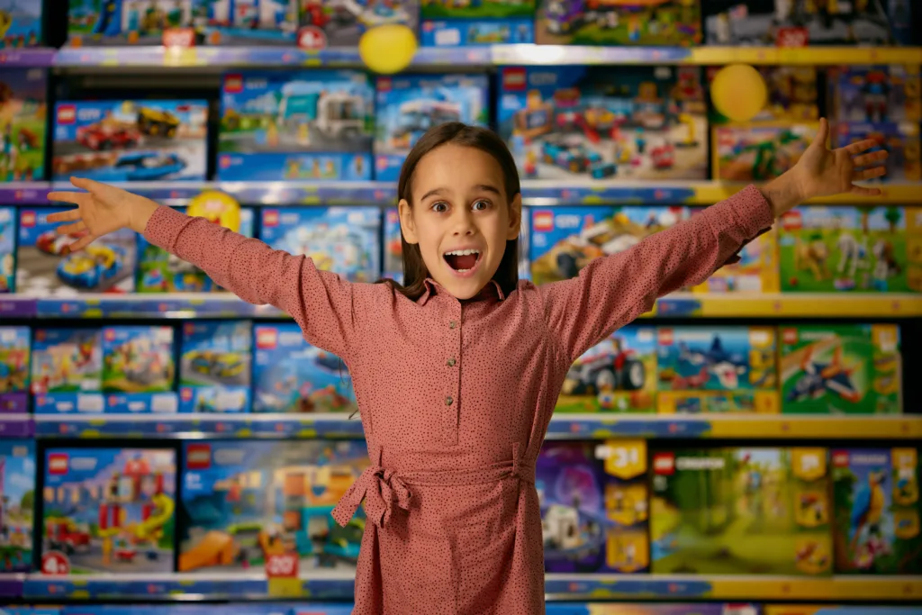 young girl excited at so many toys