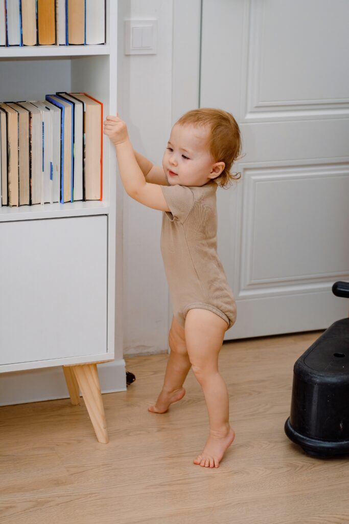 a-cute-baby-learning-to-stand-up-or-walking-with-s-2024-10-11-07-02-59-utc baby pulling up to stand