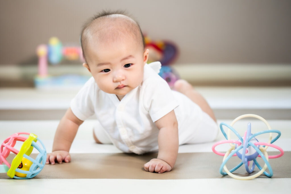 Asian baby happy in the room.Asian baby girl lying down on bed . baby during tummy time