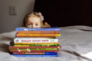 girl laying down with her books