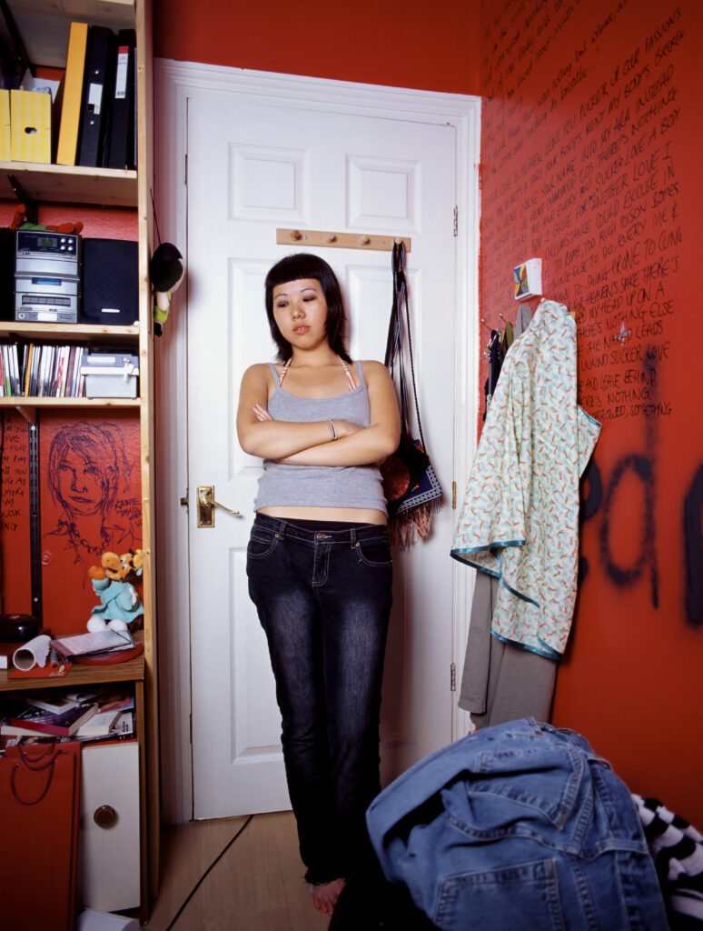Hostile teenage girl in bedroom