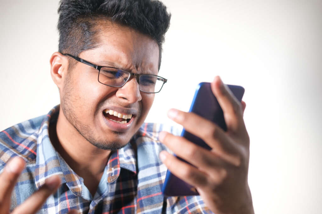 sad young man using smart phone indoor