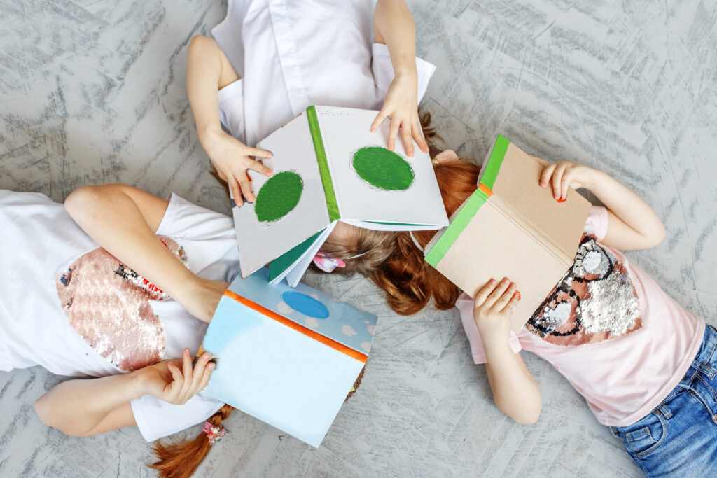 Three children of students with books. Preparation for exams. Th