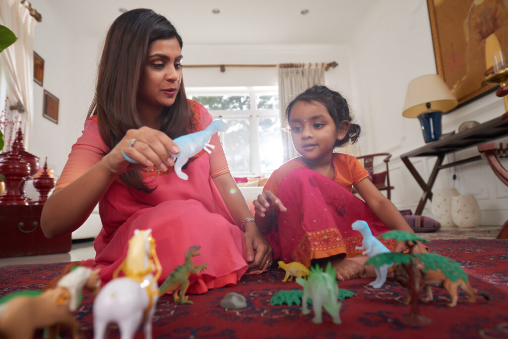 child and mother playing with animal toys instead of screentime